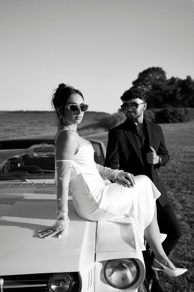 Couple pose with classic car for Aldrich Mansion engagement photos