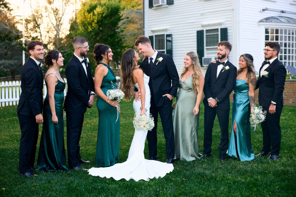 Bridal party line up beside the bride and groom at Bristol wedding in Rhode Island.
