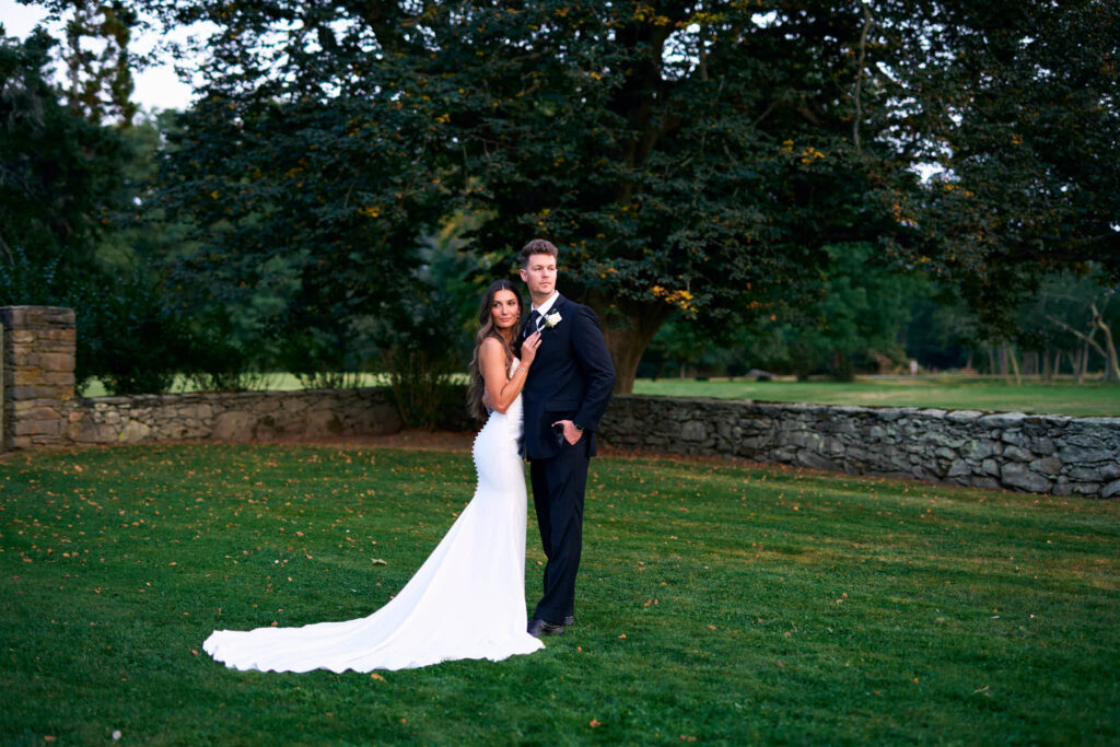 Bride and groom pose together on the grounds at Mount Hope Farm.