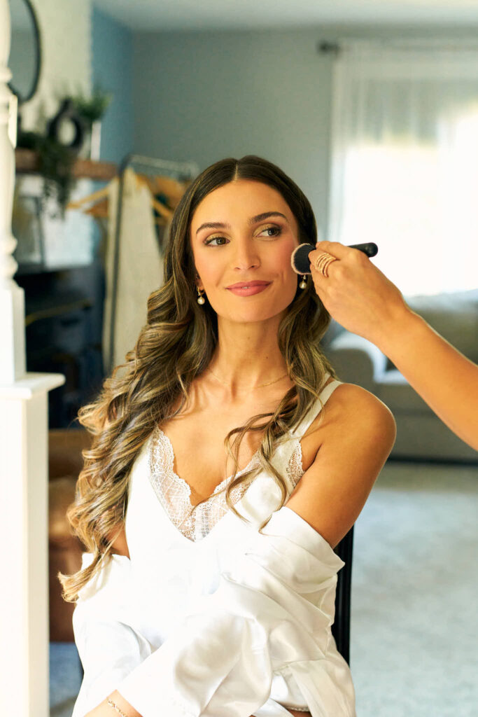 Bride gets her makeup done for her Mount Hope Farm wedding in Bristol 