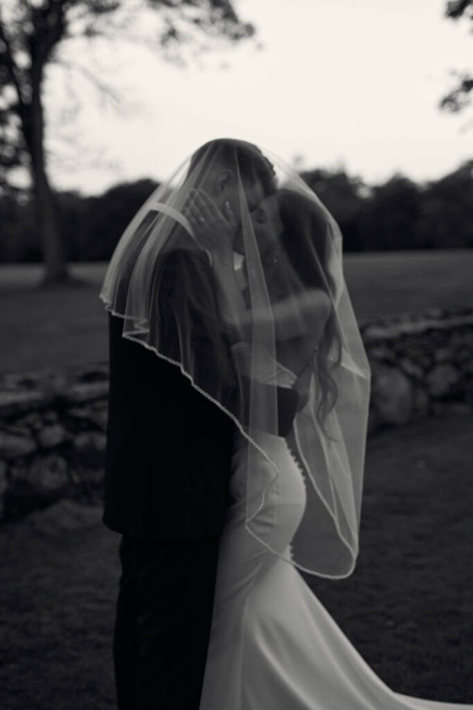 Bride and groom under a veil portrait at Mount Hope Farm in Bristol, RI.