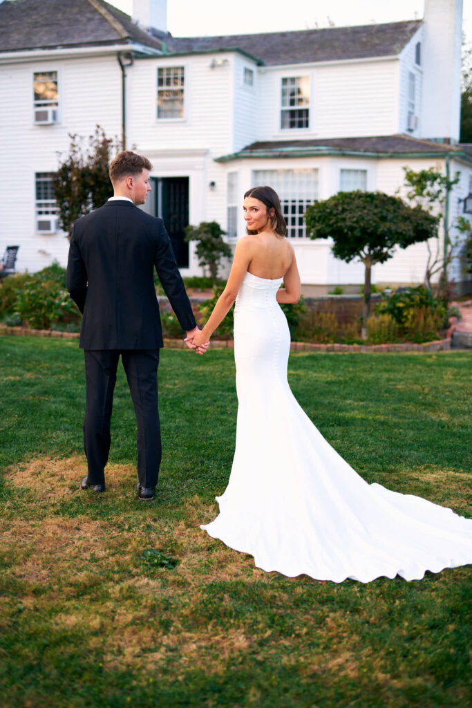 Bride and groom hold hands at Mount Hope Farm.