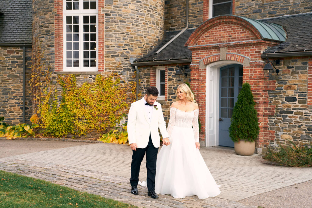 Wedding couple hold hands outside of Shepherd's Run