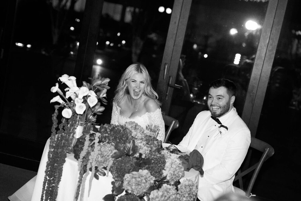 Bride and groom at their reception table at Rhode Island wedding venue Shepherd's Run