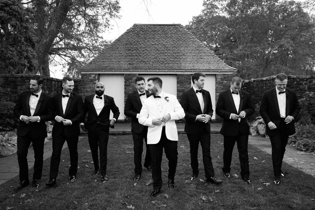 Groom and groomsmen on the Shepherd's Run gardens in Rhode Island