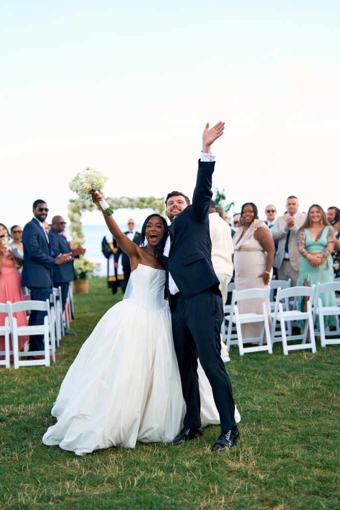 Bride and groom exit their outdoor wedding ceremony in Westbrook, Connecticut