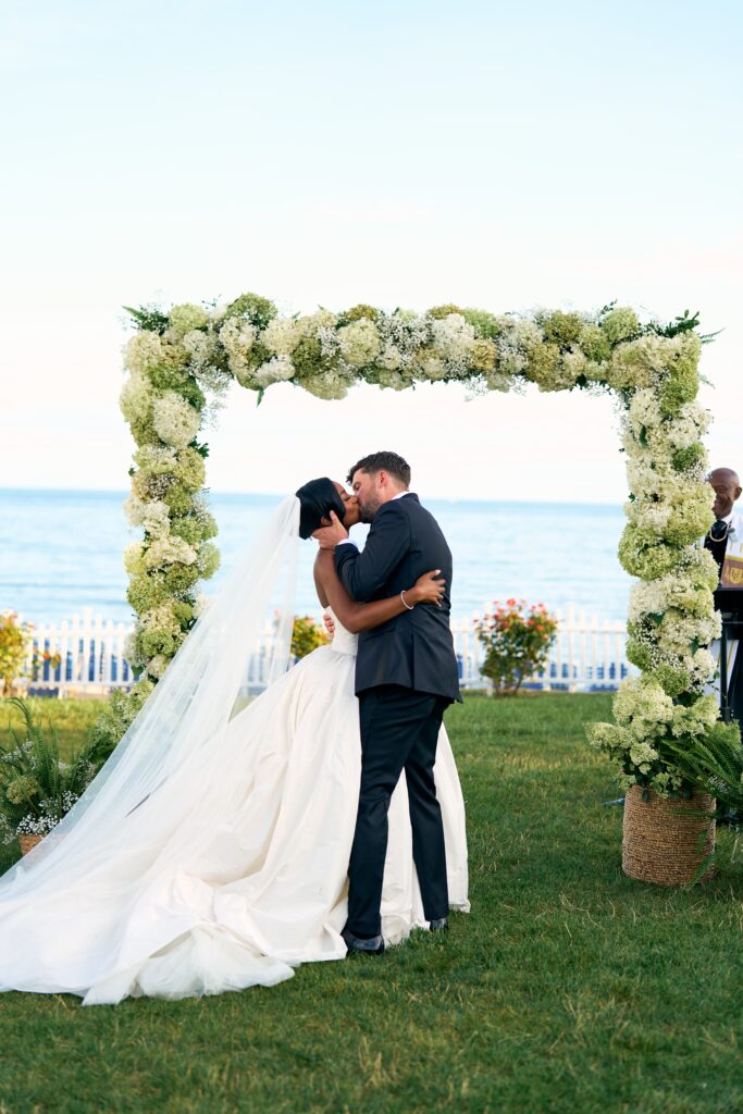 Bride and groom kiss at their waterfront wedding in Westbrook, Connecticut