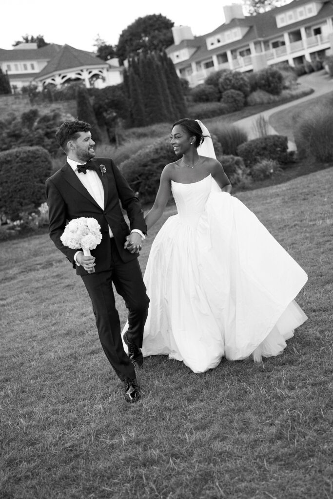 Bride and groom hold hands at Water's Edge, a Connecticut wedding venue