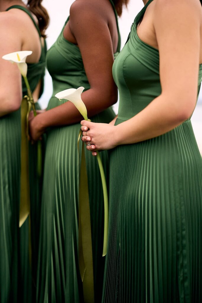 Green bridesmaid dresses and calla lily bouquet at Belle Mer wedding ceremony