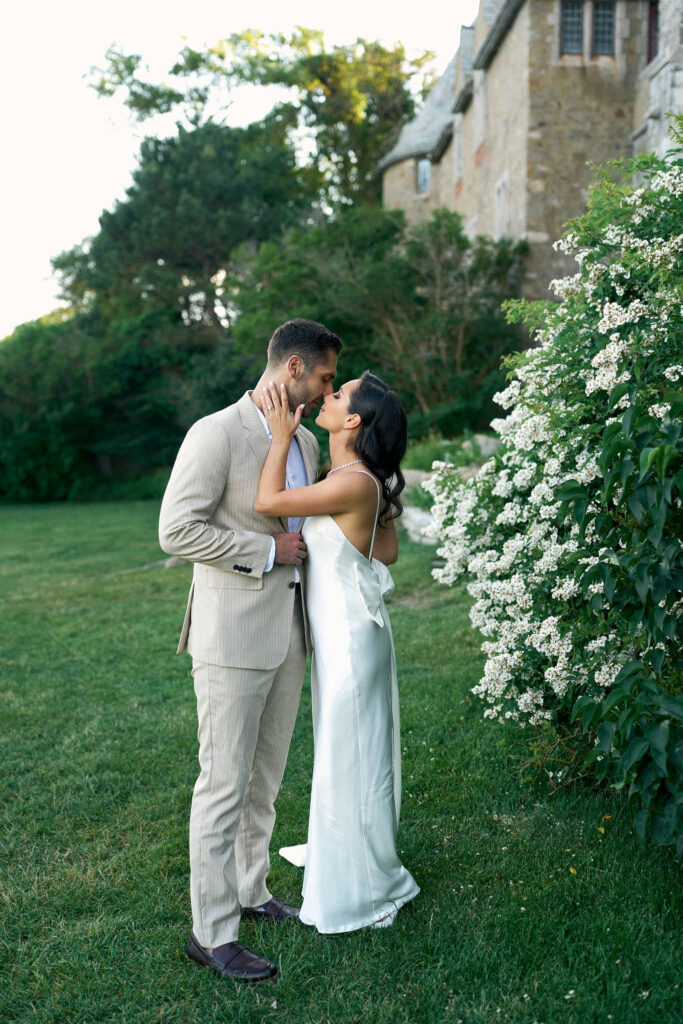 Couple kissing at Hammond Castle in Massachusetts engagement session in New England