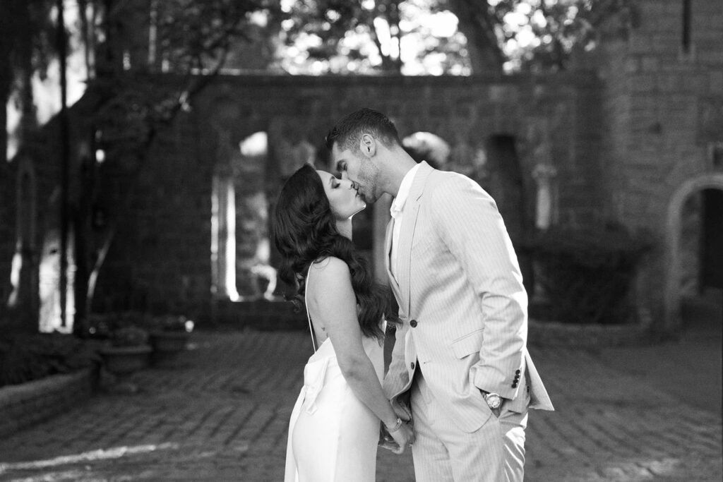 Couple kiss at Hammond Castle engagement session in New England