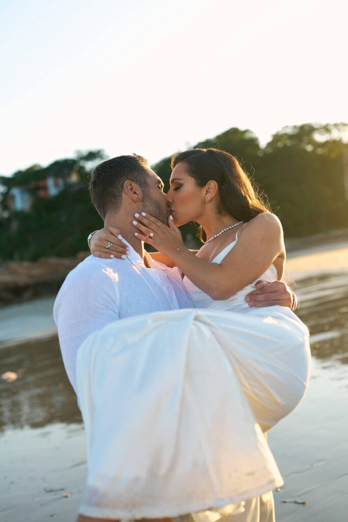 Couple kiss on the beach in Gloucester engagement session in New England